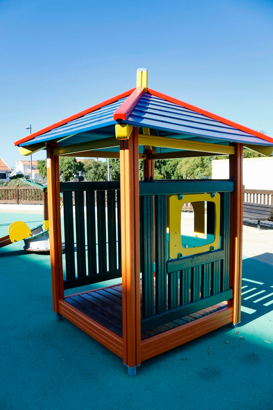 a wooden play structure with a blue roof