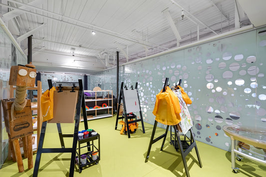 A room filled with lots of easels and paintings